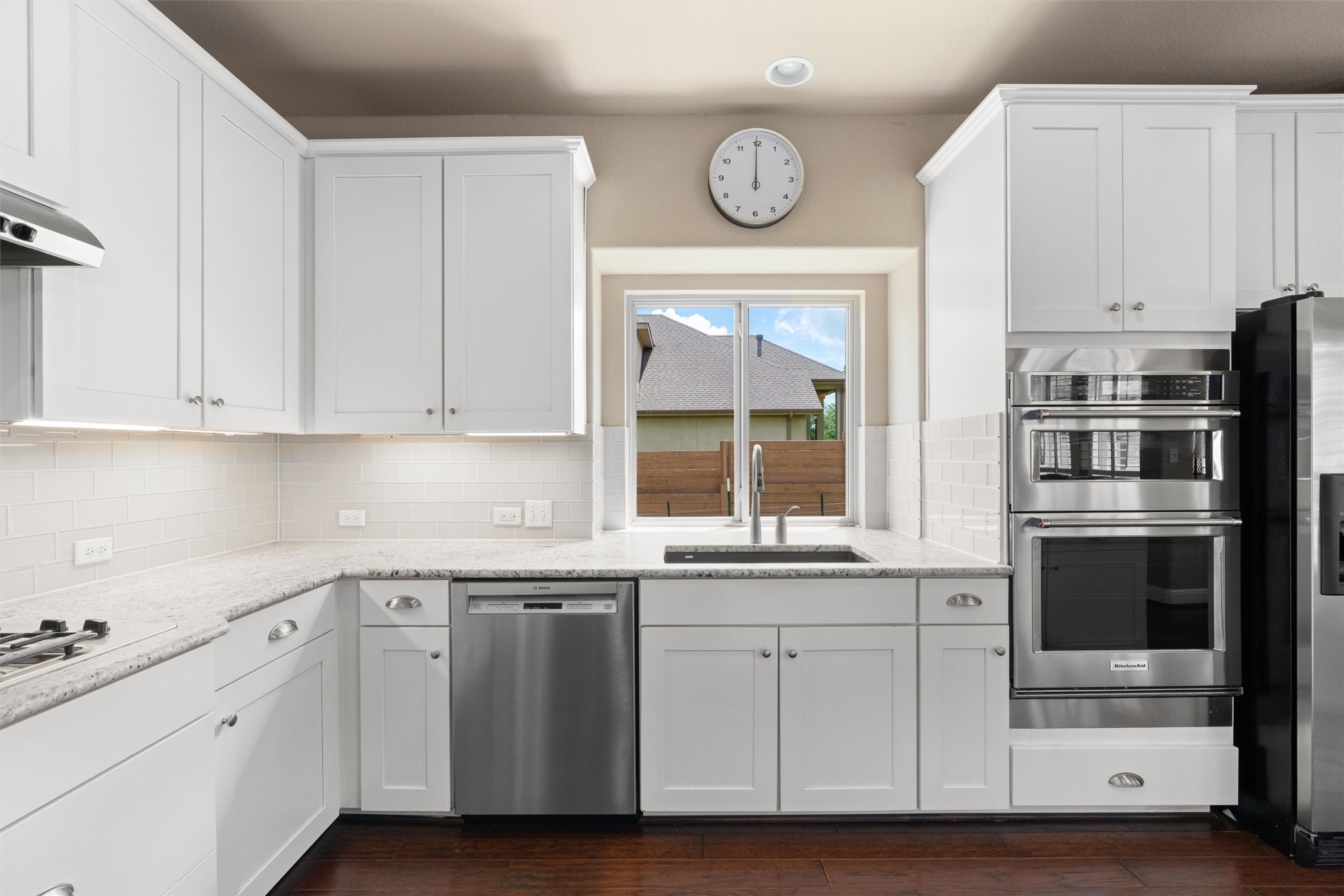 7716 Aria Loop Austin, TX 78736 - Photo 11 of 39 A well-appointed culinary space boasts ample white cabinetry, gleaming countertops, and modern stainless steel appliances.