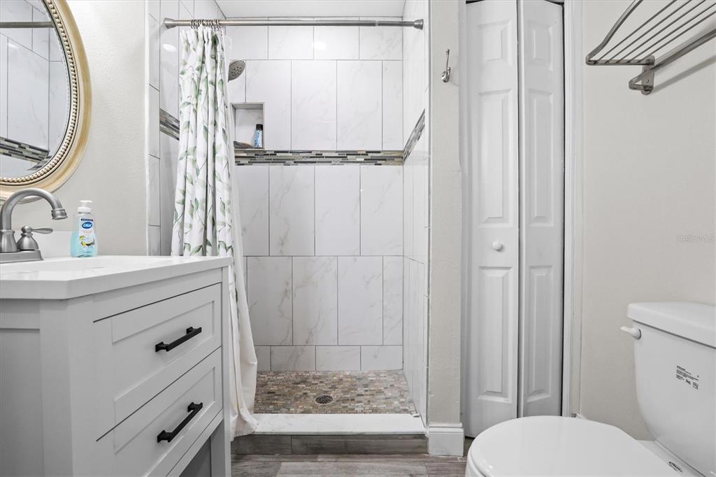 6244 Colony Circle Weeki Wachee, FL 34607 - Photo 52 of 60 a bathroom with a granite countertop sink toilet and shower