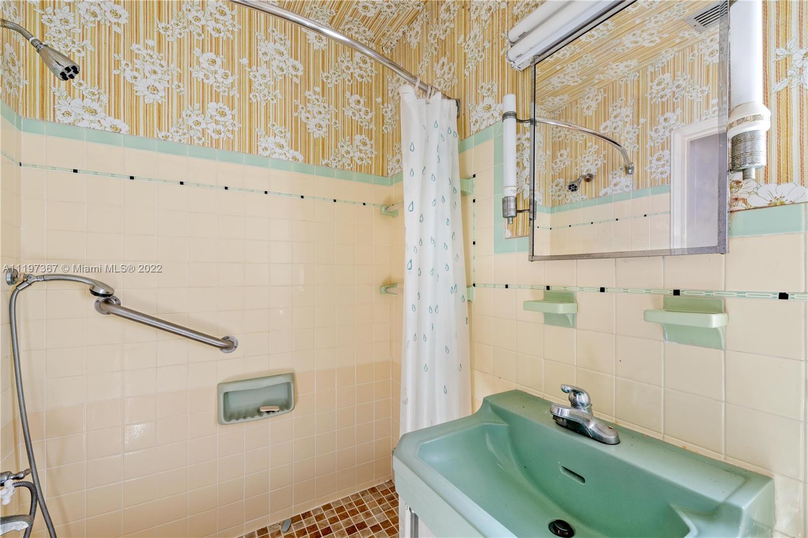 531 Northeast 55th Terrace Miami, FL 33137 - Photo 11 of 22 a bathroom with a sink and a mirror