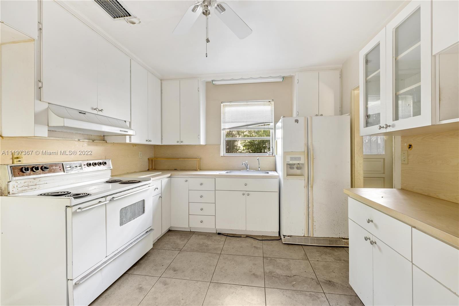 531 Northeast 55th Terrace Miami, FL 33137 - Photo 14 of 22 a kitchen with white cabinets and white appliances