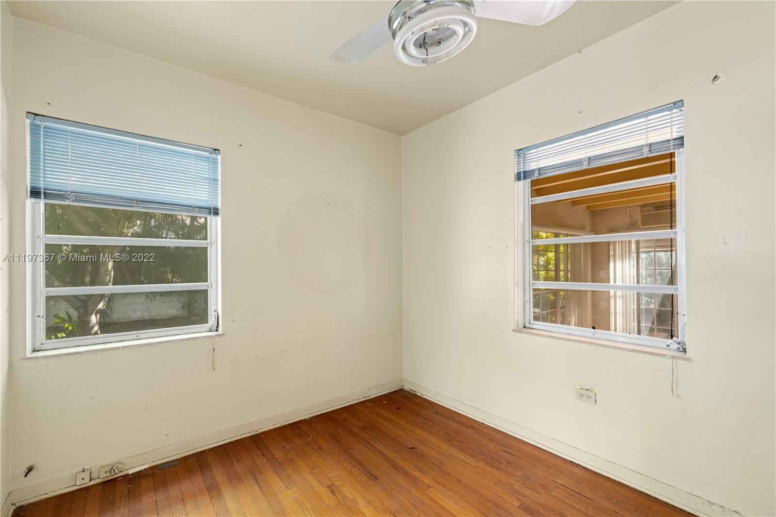 531 Northeast 55th Terrace Miami, FL 33137 - Photo 15 of 22 a view of an empty room with wooden floor and a window