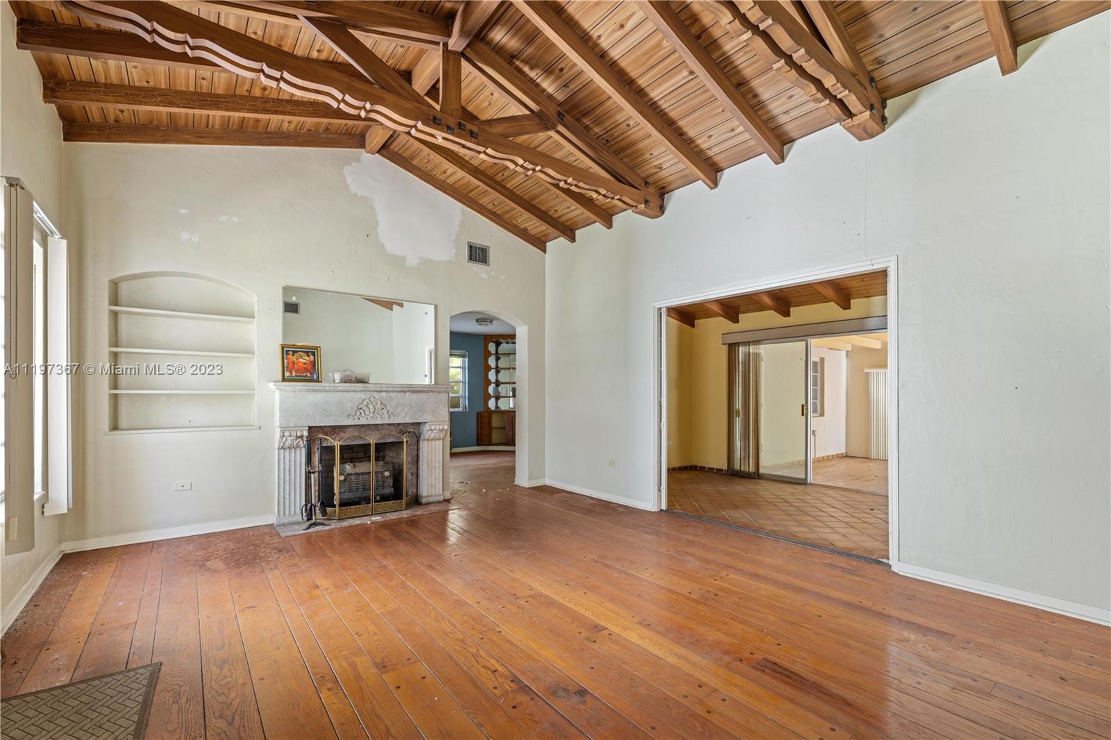 531 Northeast 55th Terrace Miami, FL 33137 - Photo 9 of 22 a view of empty room with a fireplace and wooden floor