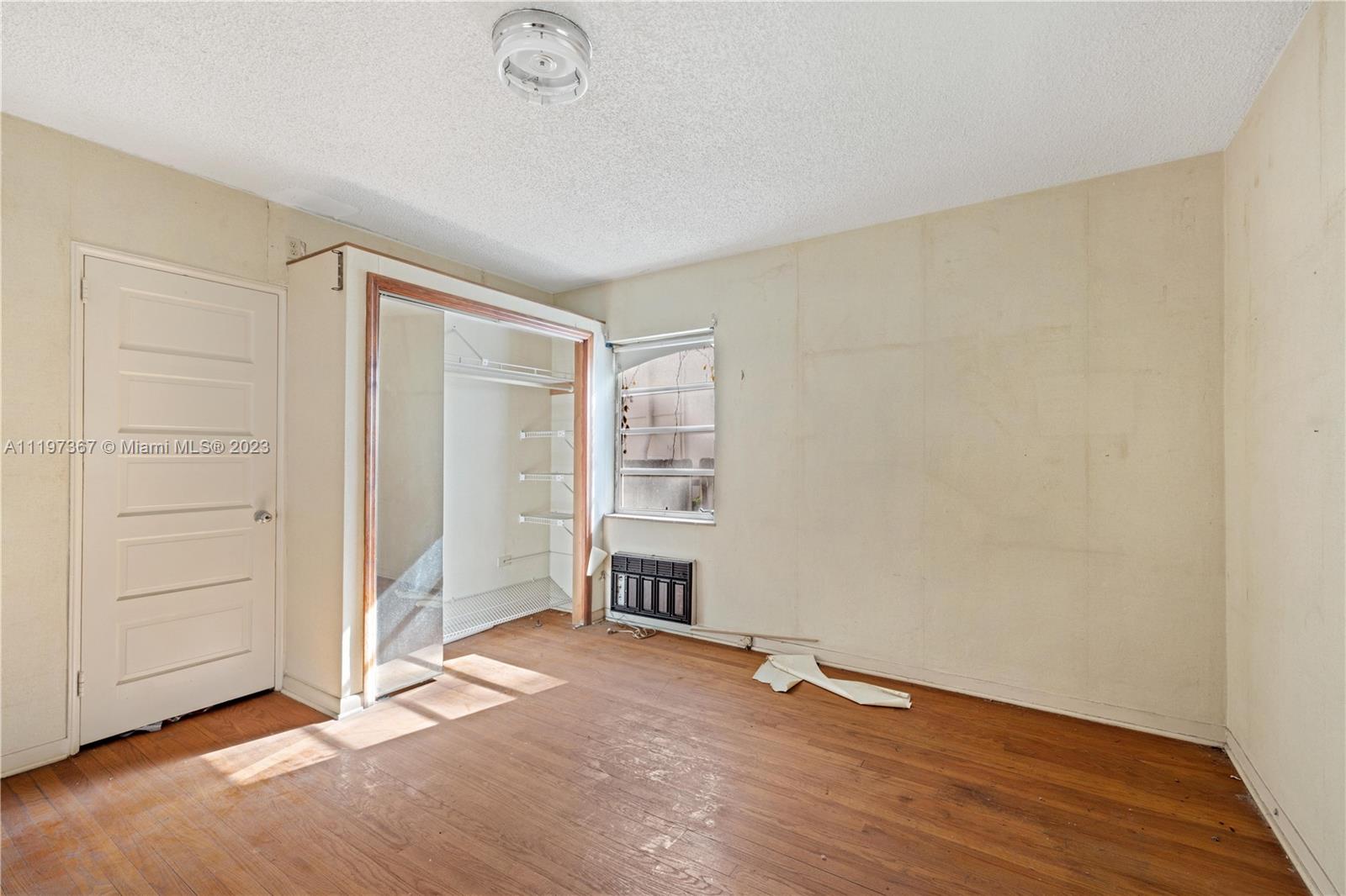 531 Northeast 55th Terrace Miami, FL 33137 - Photo 10 of 22 an empty room with wooden floor cabinet and windows