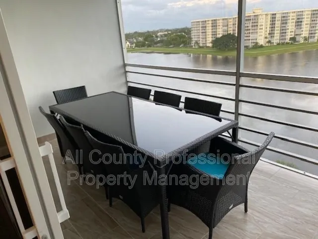 a view of a balcony dining table and chairs