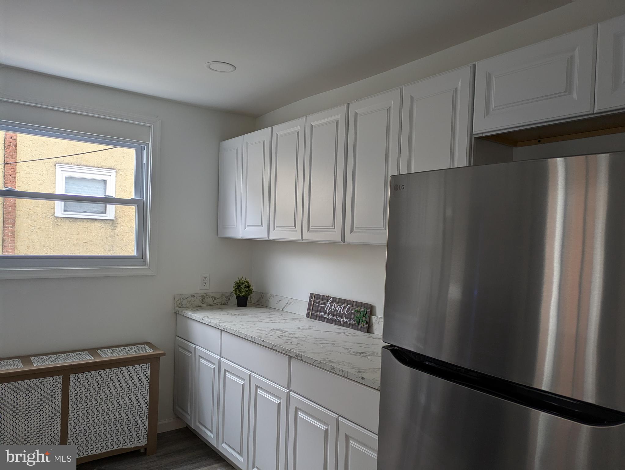 417 Copley Road Upper Darby, PA 19082 - Photo 2 of 23 a kitchen with stainless steel appliances granite countertop a refrigerator a sink and white cabinets