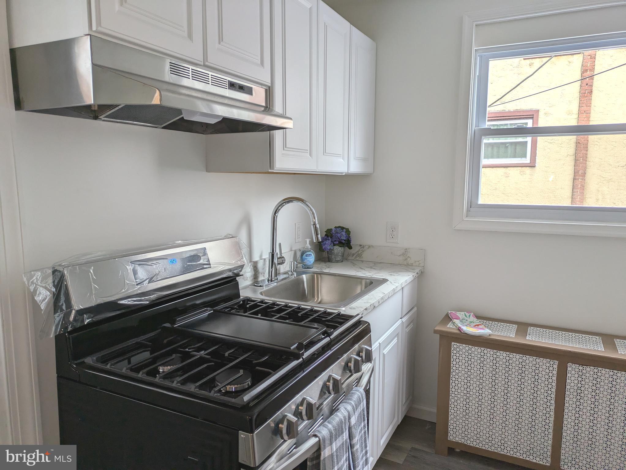 417 Copley Road Upper Darby, PA 19082 - Photo 3 of 23 a kitchen with stainless steel appliances granite countertop a sink stove and cabinets