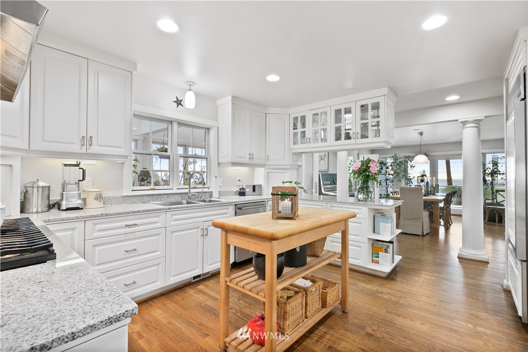 16119 73rd Place West Edmonds, WA 98026 - Photo 18 of 40 a kitchen with stainless steel appliances granite countertop a stove top oven a sink a counter space and living room view
