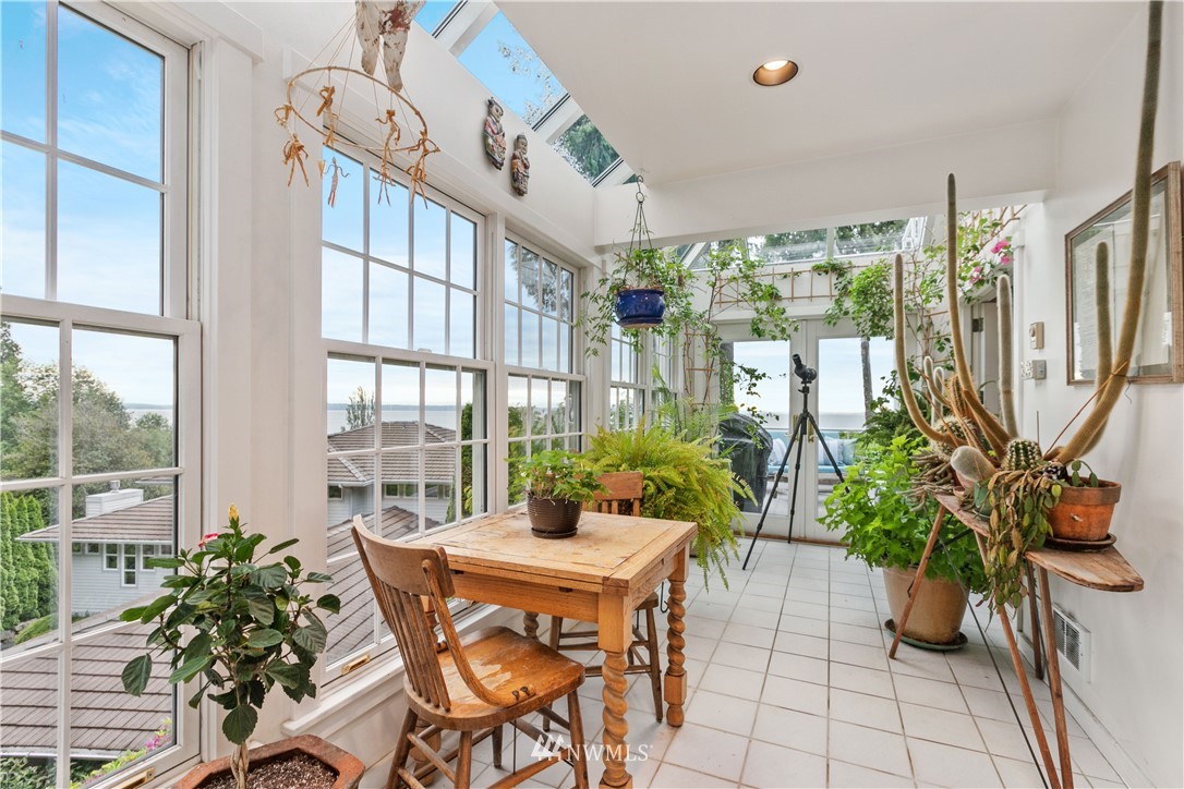 16119 73rd Place West Edmonds, WA 98026 - Photo 19 of 40 a dining room with furniture potted plants and wooden floor