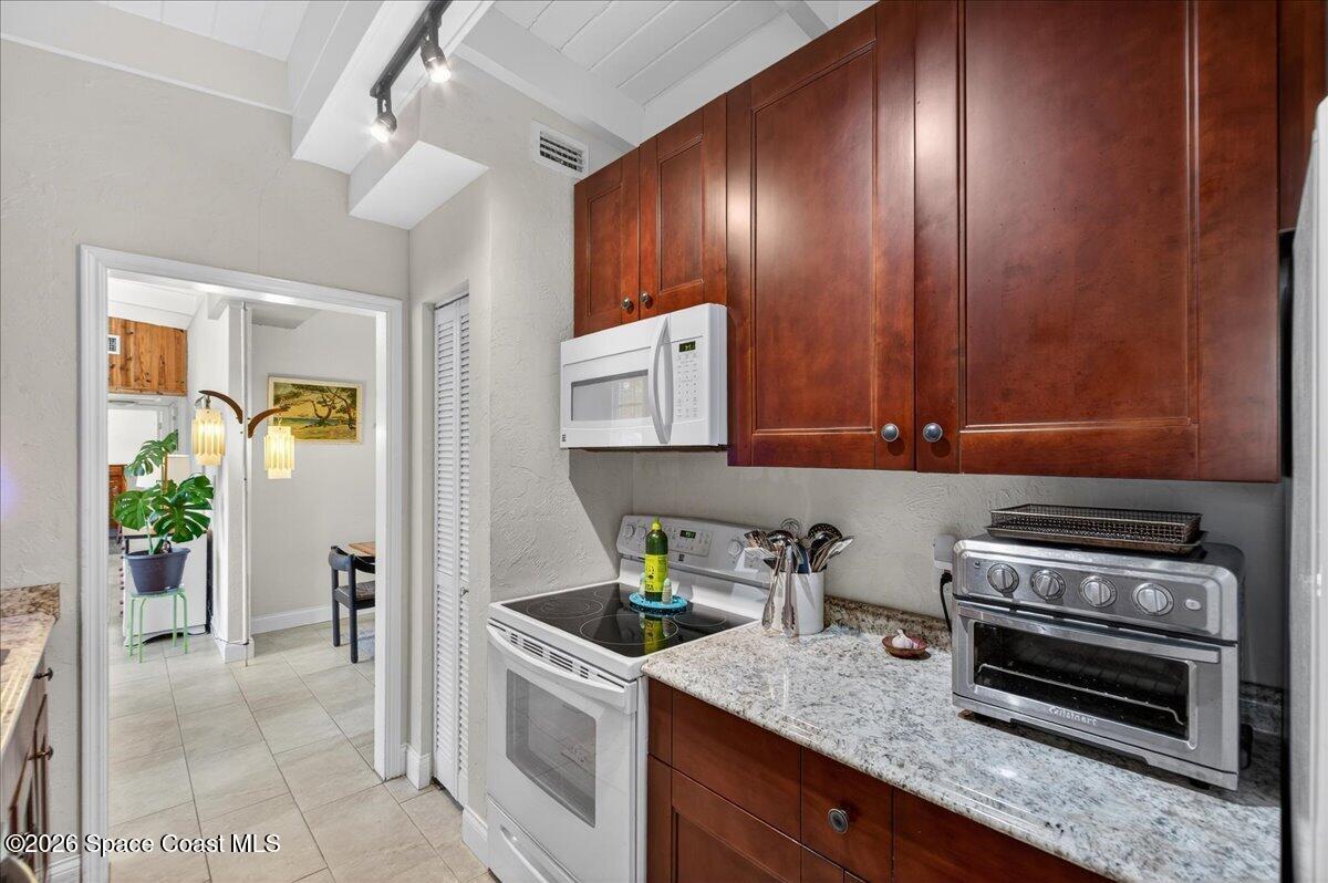 1615 Grandview Way Melbourne, FL 32935 - Photo 11 of 34 a kitchen that has a sink a stove and cabinets