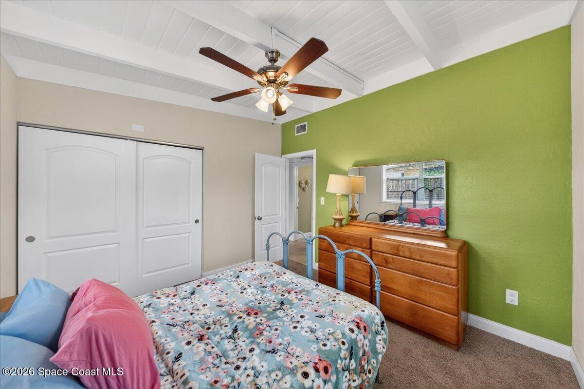 1615 Grandview Way Melbourne, FL 32935 - Photo 18 of 34 a bedroom with a bed and a chandelier