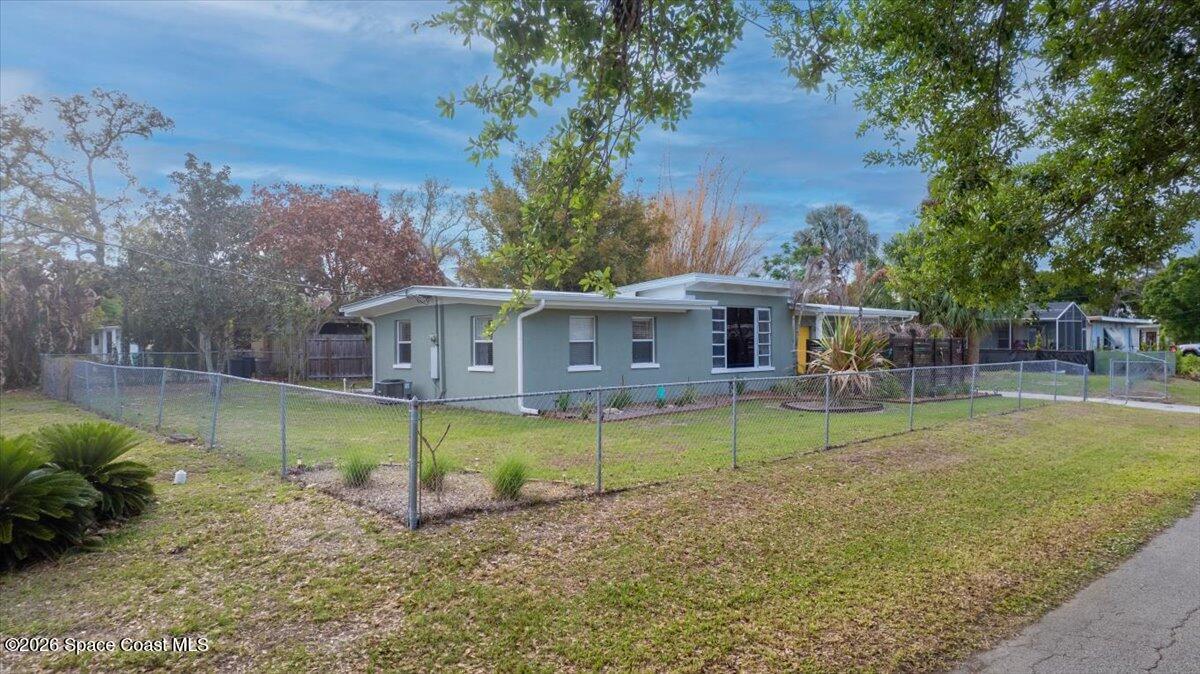 1615 Grandview Way Melbourne, FL 32935 - Photo 28 of 34 a view of a house with a yard and a patio