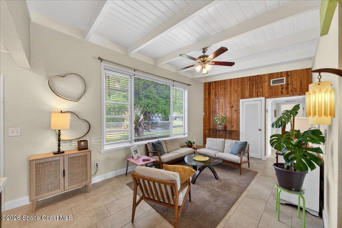 1615 Grandview Way Melbourne, FL 32935 - Photo 3 of 34 a living room with furniture a chandelier and a window