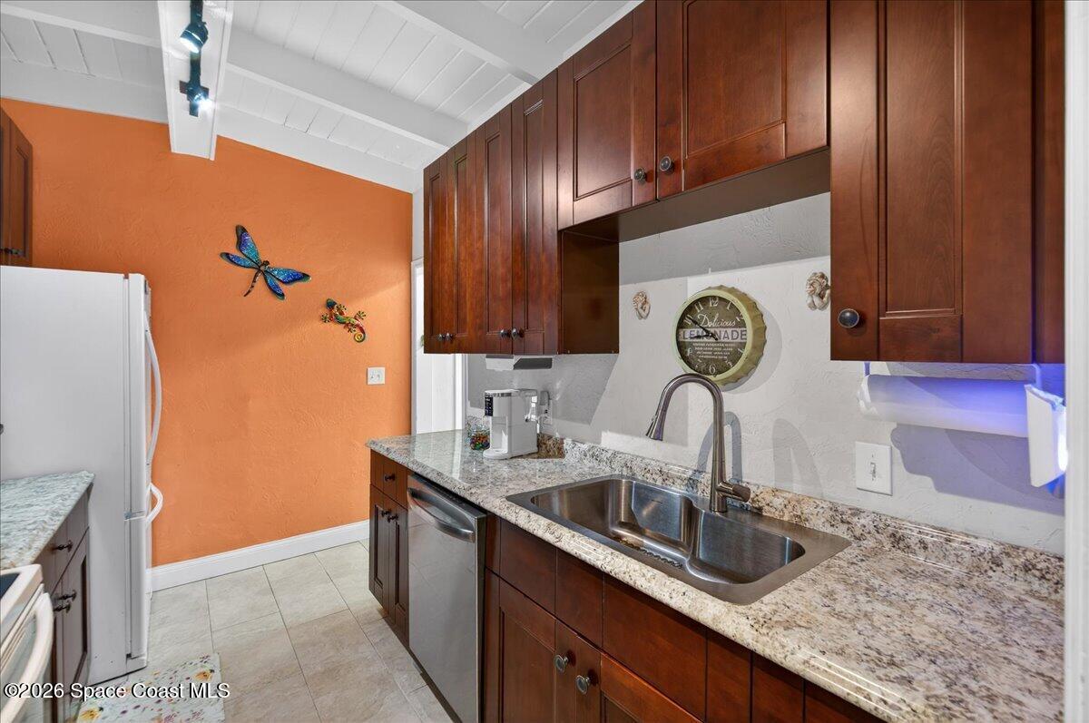 1615 Grandview Way Melbourne, FL 32935 - Photo 10 of 34 a kitchen with stainless steel appliances granite countertop a sink stove and refrigerator