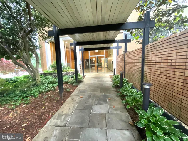 a view of a hallway with wooden floor and entryway