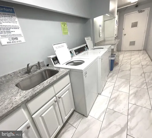 a kitchen with granite countertop white cabinets and a stove