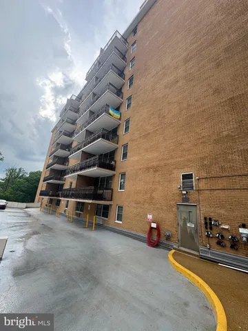 a living room with a washing machine and a sink