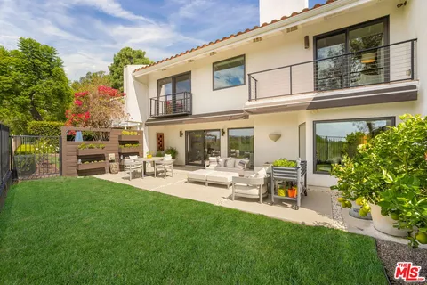 a large white kitchen with a large window