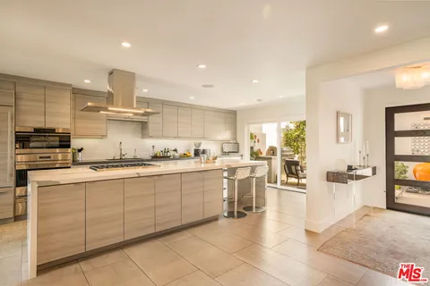 a kitchen with stainless steel appliances kitchen island granite countertop a sink and cabinets