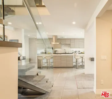 a kitchen with granite countertop a sink and white cabinets