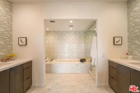 a bathroom with a bathtub and shower