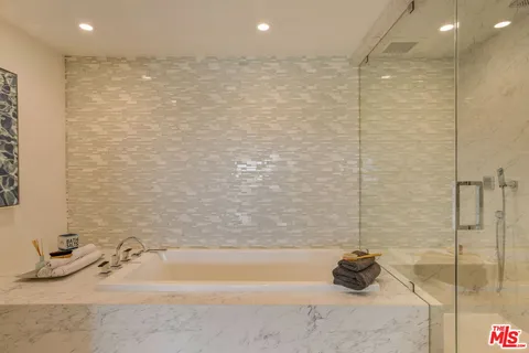 a bathroom with a glass shower door