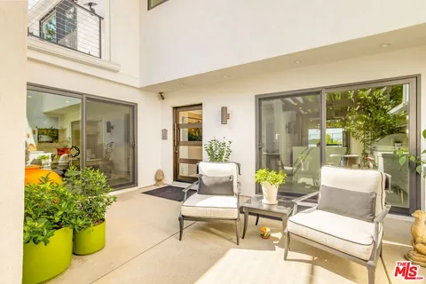 a lobby with furniture and floor to ceiling windows