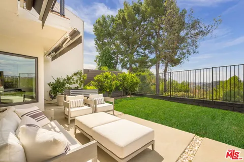 a view of a house with backyard porch and sitting area