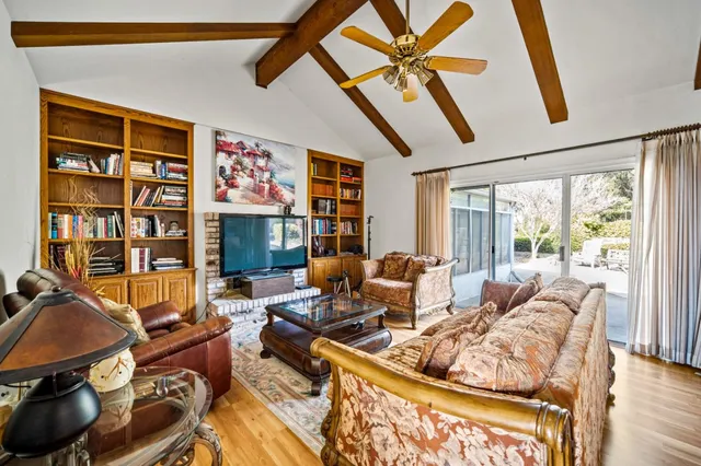 a living room with furniture a fireplace and a flat screen tv
