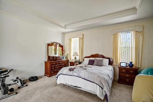 a bedroom with a bed and dresser with mirror