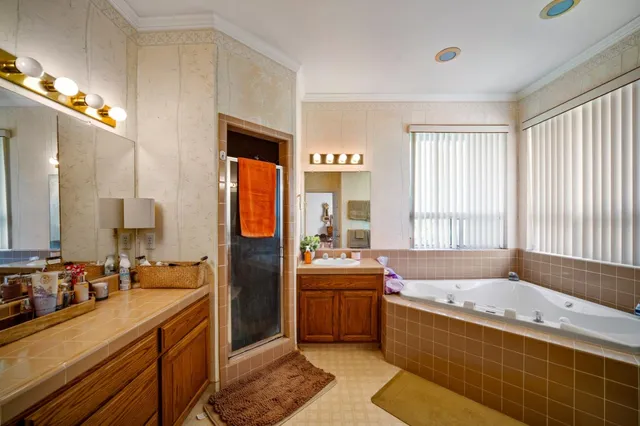 a large bathroom with a large tub shower and sink