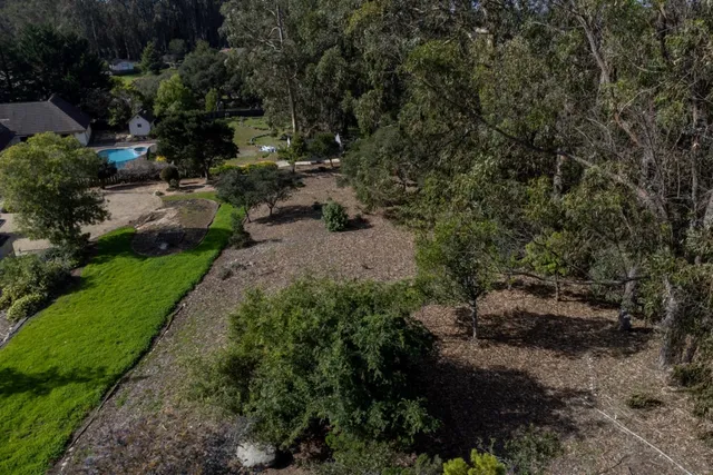 a backyard of a house with a yard and outdoor seating