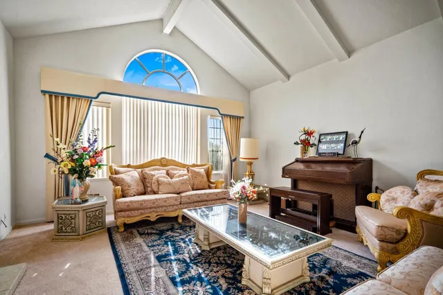 a living room with furniture and a potted plant