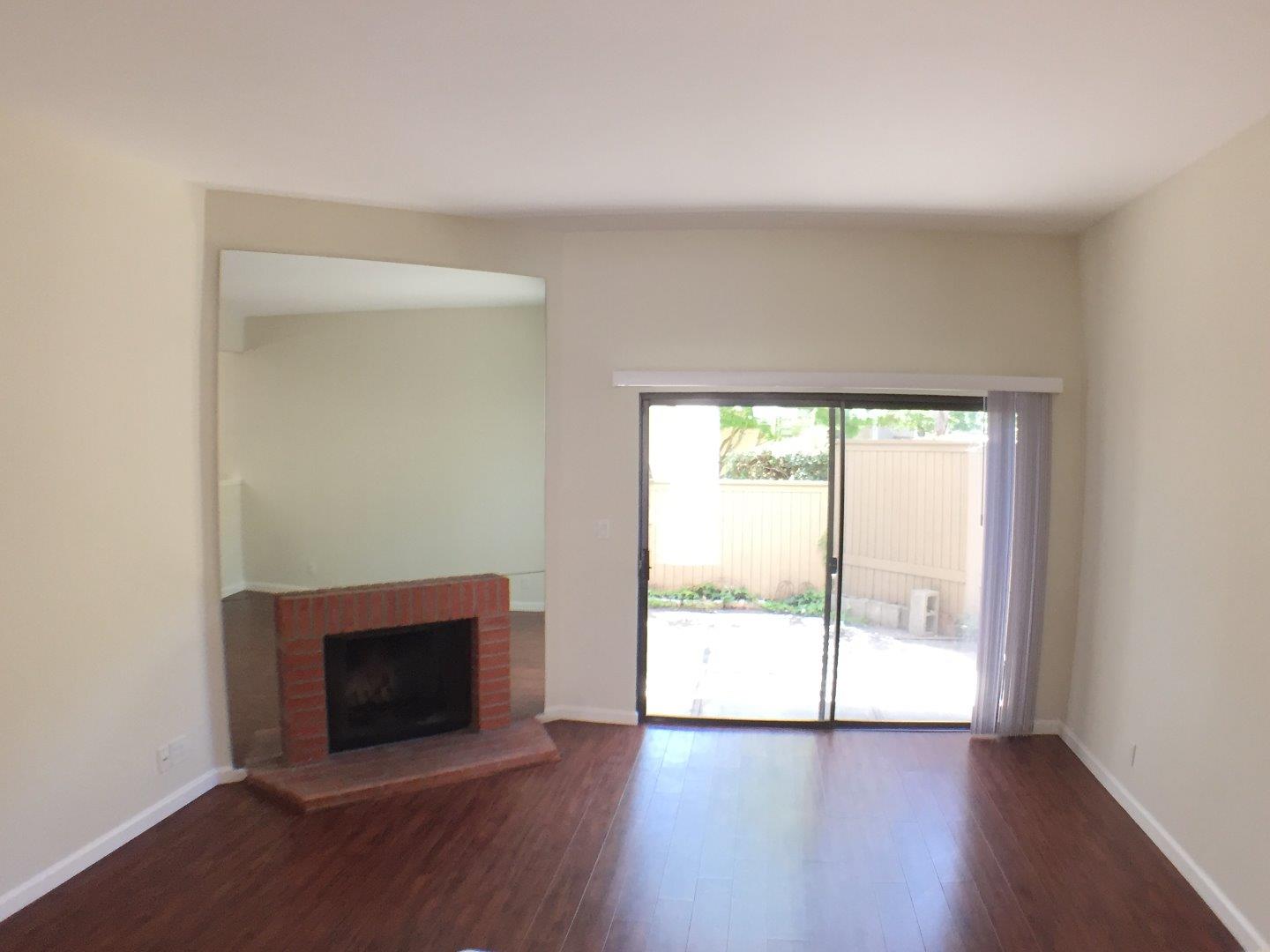 102 Marylinn Drive Milpitas, CA 95035 - Photo 4 of 18 an empty room with wooden floor and windows