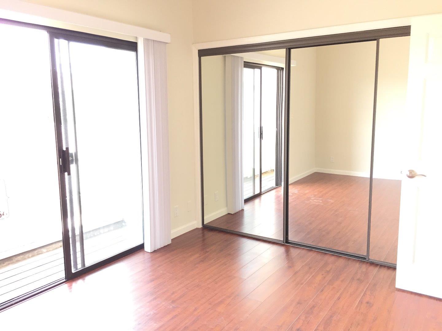 102 Marylinn Drive Milpitas, CA 95035 - Photo 8 of 18 an empty room with wooden floor and windows
