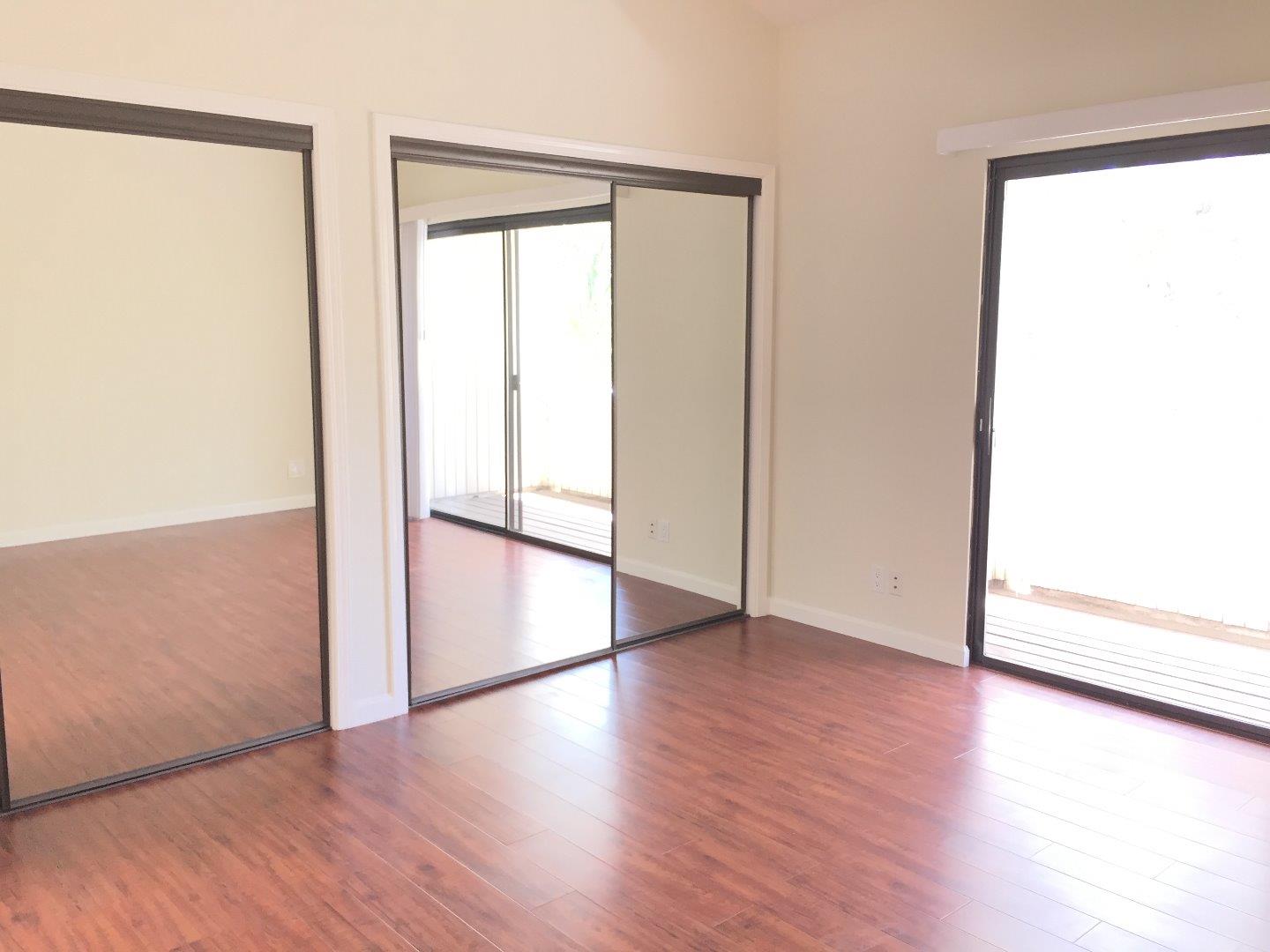 102 Marylinn Drive Milpitas, CA 95035 - Photo 9 of 18 an empty room with wooden floor and a window