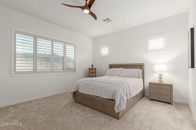 a bedroom with a bed and a mirror