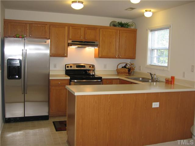 4211 Wellington Ridge Loop Cary, NC 27518 - Photo 5 of 22 NEW (June 2011) Stainless Side-by-Side Fridge, Range & Hood. Updated flooring, lighting and recently painted. Ample entertaining space with this extended breakfast bar peninsula; allows the chef to stay part of conversations and celebrations. Kitchen