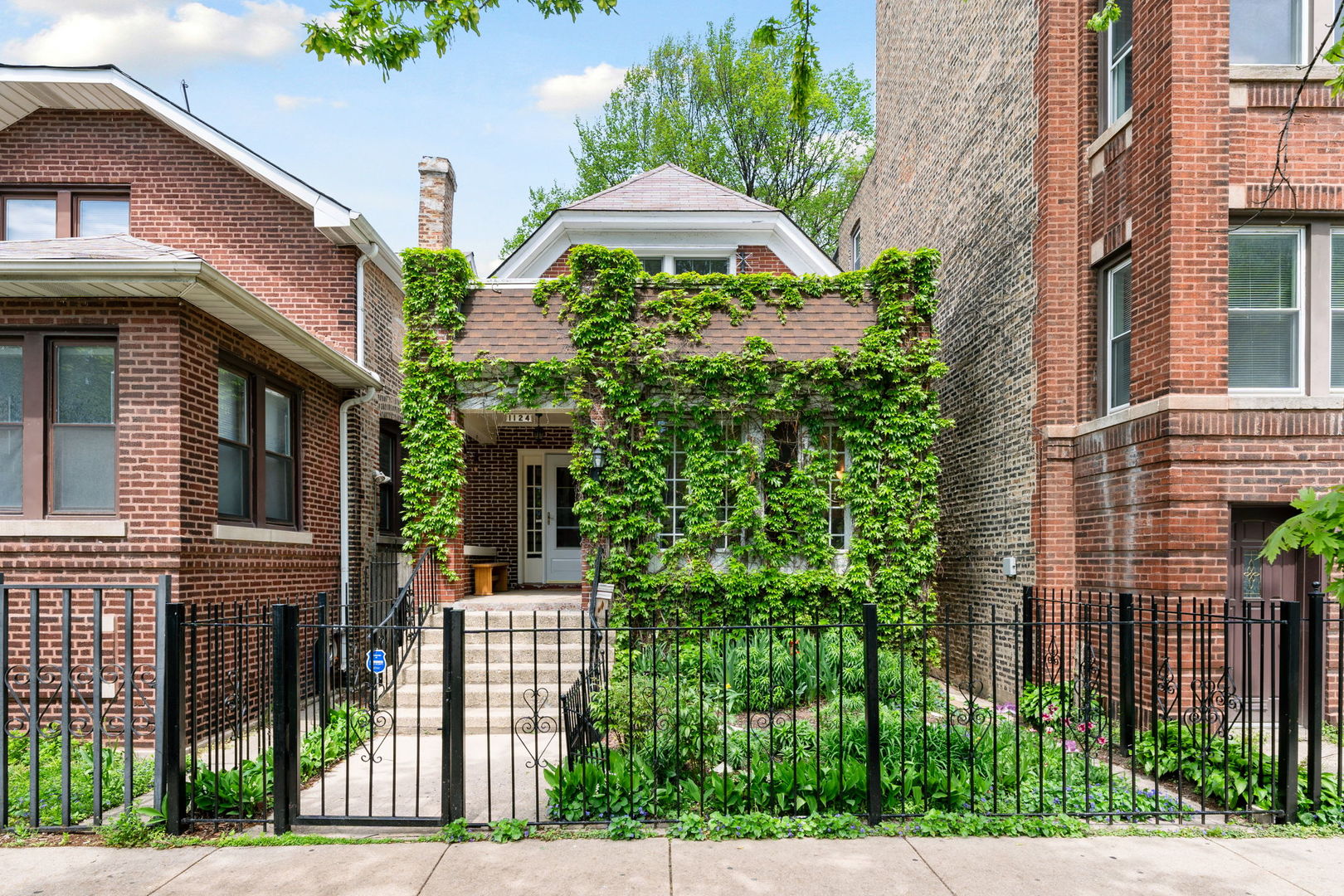 a front view of a house with plants