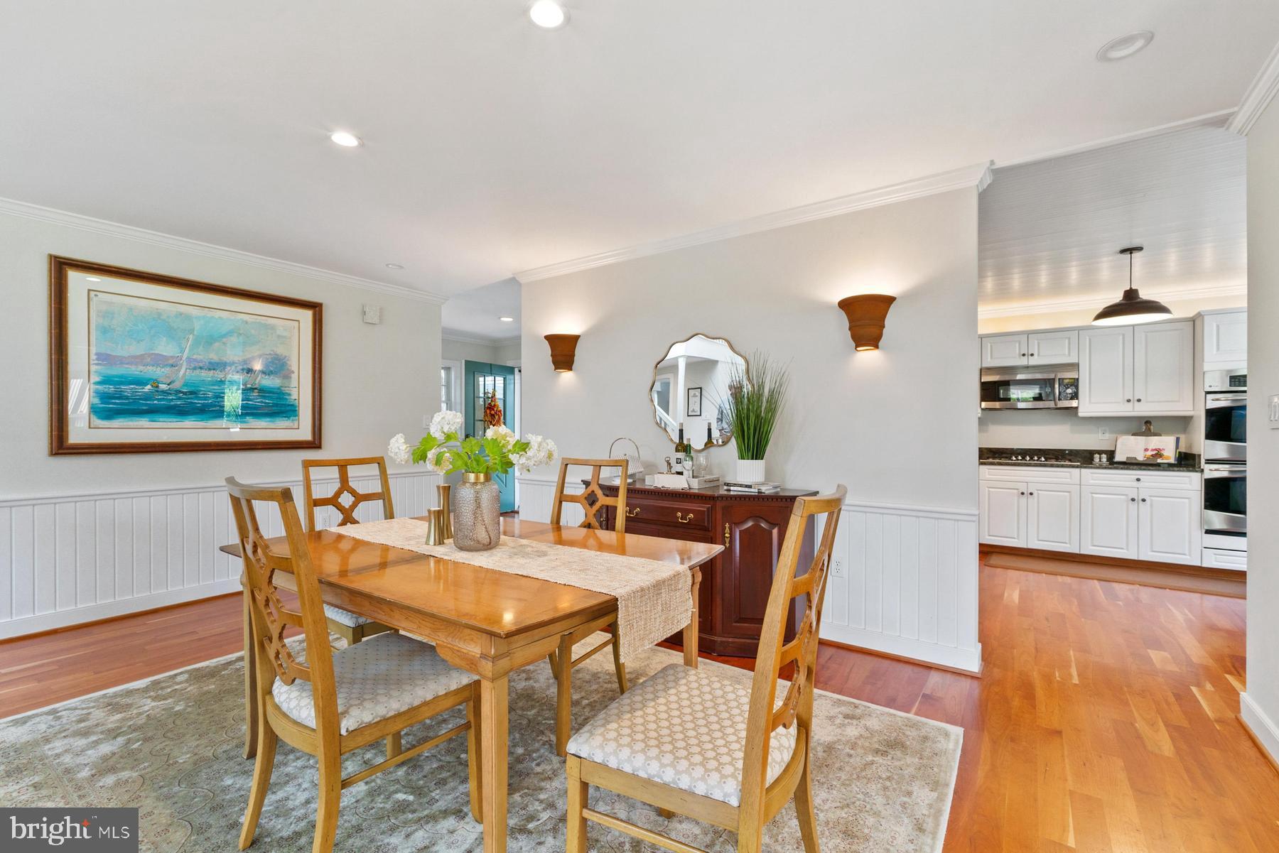 8095 Church Neck Road St. Michaels, MD 21663 - Photo 13 of 48 a view of a dining room with furniture and wooden floor