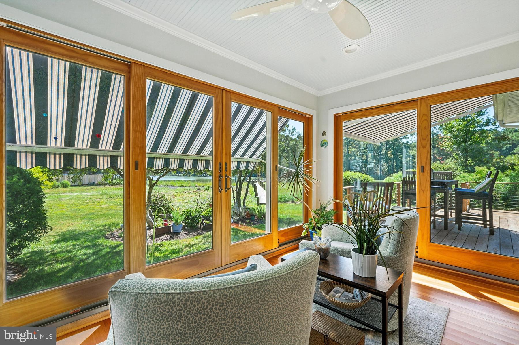 8095 Church Neck Road St. Michaels, MD 21663 - Photo 14 of 48 a living room with large windows and furniture