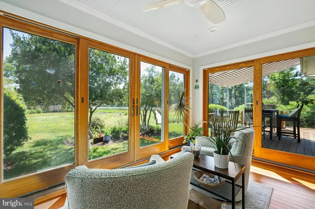 a living room with pool table and chairs