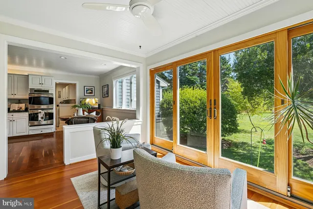 a living room with furniture and large windows