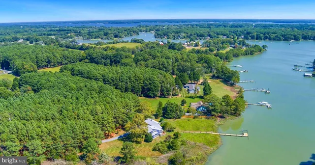 an aerial view of a houses with a yard