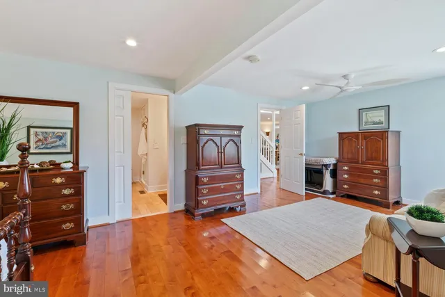 a bedroom with furniture and a flat screen tv