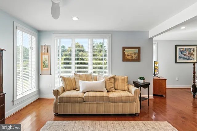 a bedroom with furniture and wooden floor