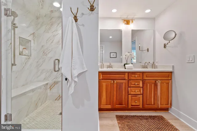 a bathroom with a sink a mirror and a shower