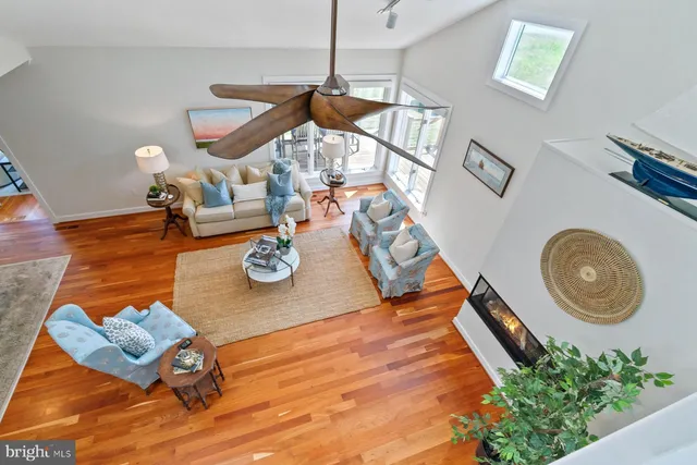 a living room with furniture and flowers