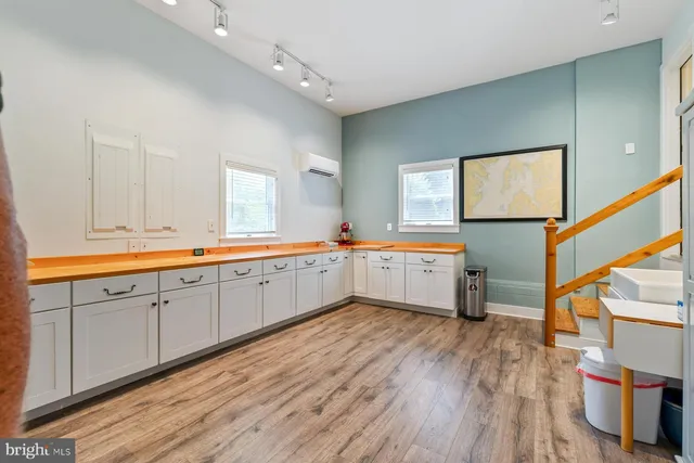 a kitchen with sink cabinets and wooden floor