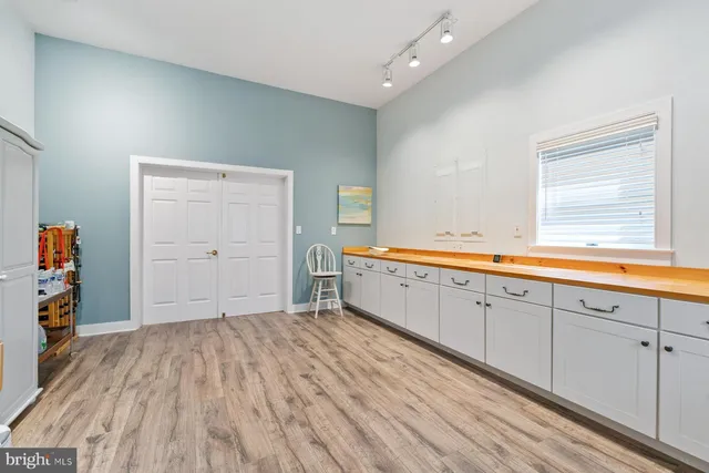 a spacious bathroom with a sink and a mirror
