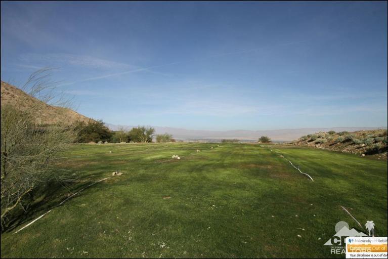 a view of a field with an ocean